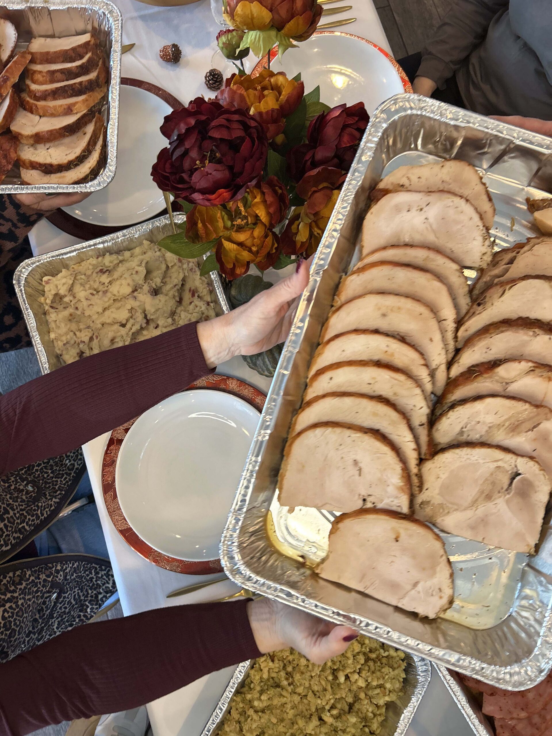 Sliced turkey and sides ready for a Thanksgiving gathering